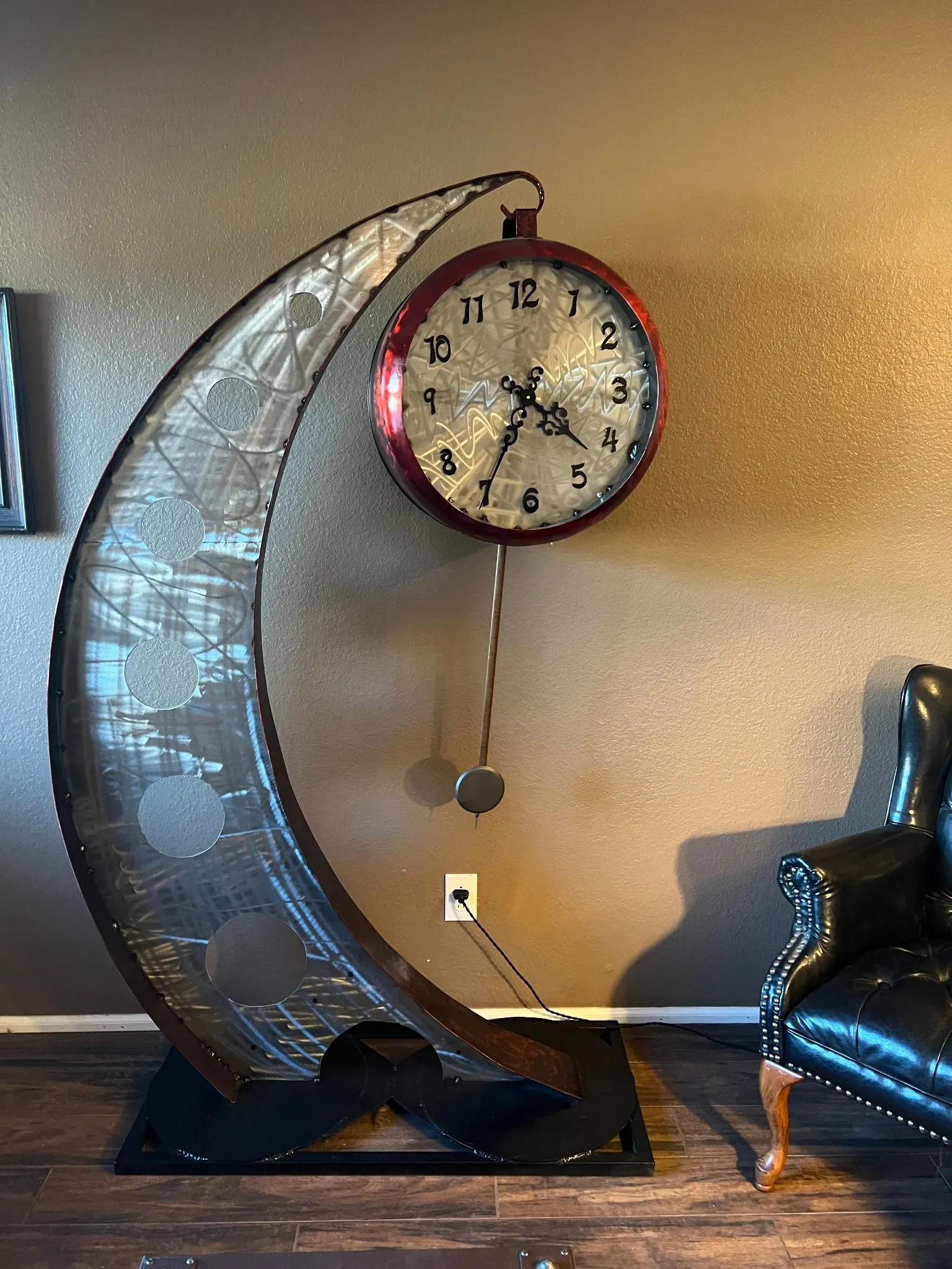 Crescent moon floor clock with pendulum in steel