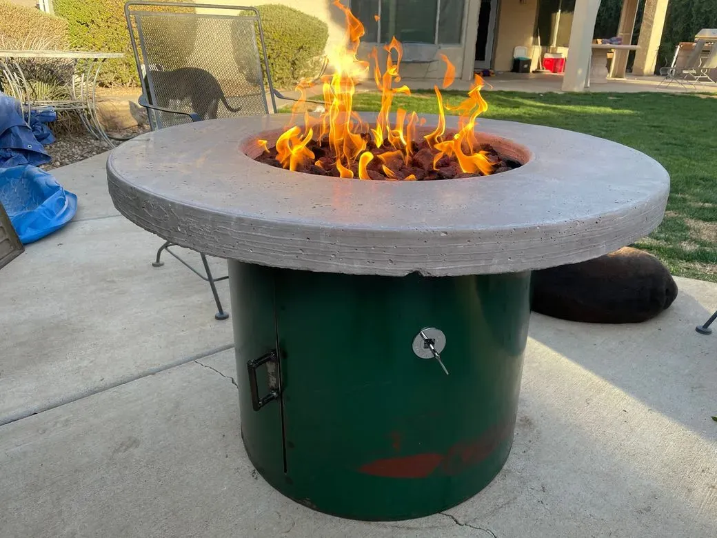 Fire pit table with concrete top on a green steel drum base